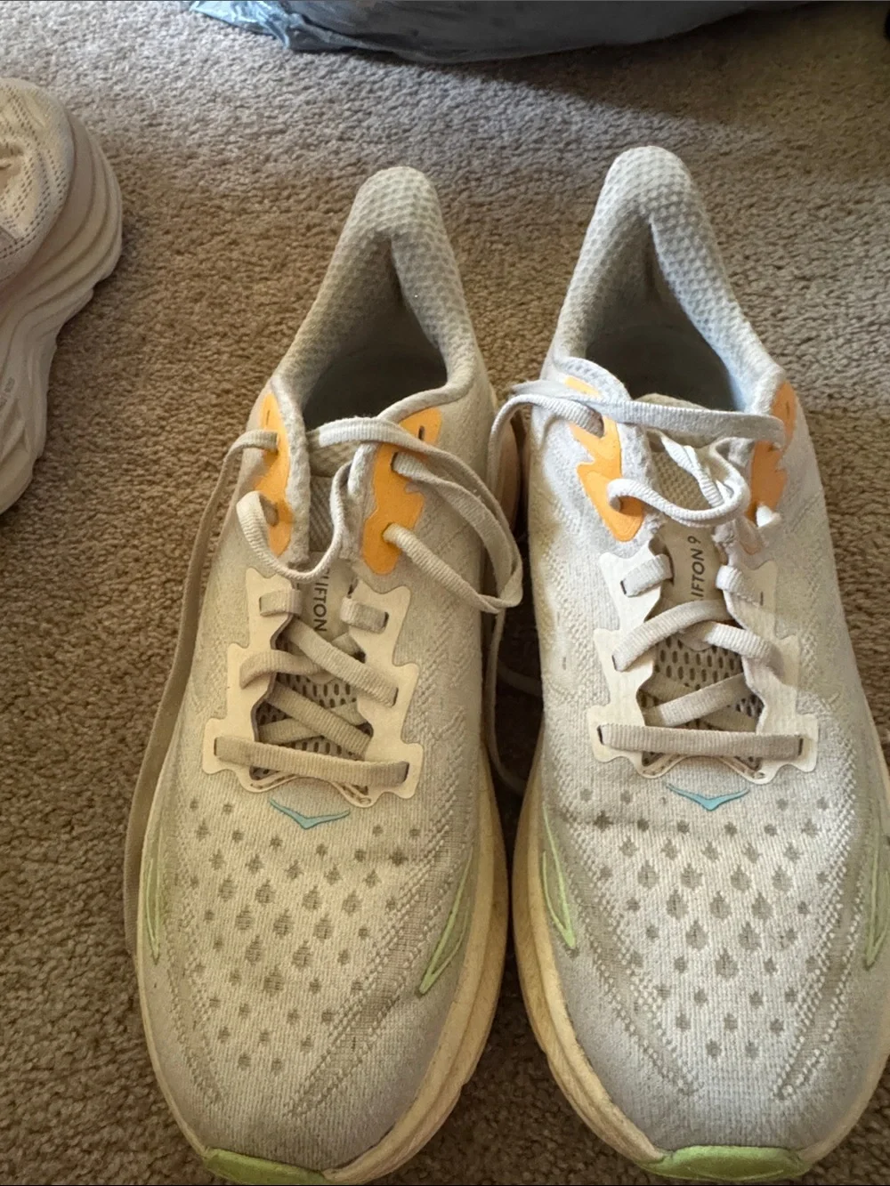 Hoka one women’s  White Running Shoes with Yellow Accents Clifton 9